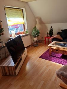 a living room with a flat screen tv on a table at Ferienwohnung Bluhm Wahlstedt 