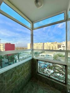 a balcony with a view of a city at Refined Me Apartment Bb in Casablanca