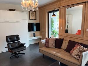 a living room with a couch and a chair at Saint Germain in Colmar