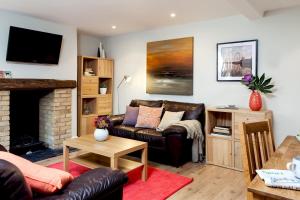 a living room with a couch and a fireplace at Madison Hill - Fernlea Garden 2 - One bedroom home in London