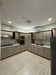 a large kitchen with white cabinets and appliances at ٣ غرف و صاله in Riyadh