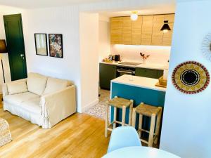 a living room and kitchen with a couch and a table at Appart 40m2 dans maison - Proche Paris in Meudon