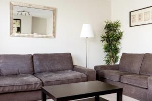 a living room with a couch and a table at Madison Hill - Fernlea View 4 - Two bedroom flat in London