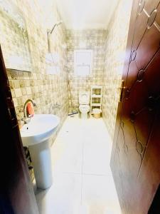 a small bathroom with a sink and a toilet at Afnan Cairo Airport in Cairo