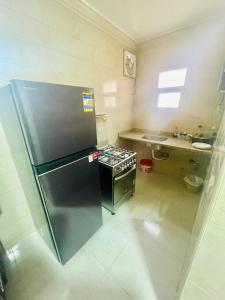 a kitchen with a refrigerator and a stove in it at Afnan Cairo Airport in Cairo