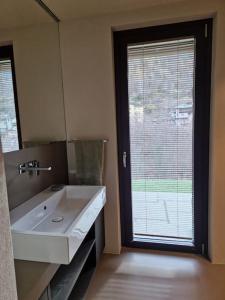 a bathroom with a sink and a large window at Little Paradise - Ampio Monolocale in Arvier