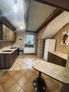 a kitchen with a table and a refrigerator at Cyziówka in Kamionka +196 photos
