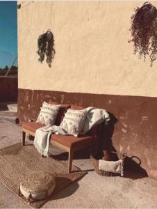 a couch with pillows on it next to a wall at Casa De La Era 