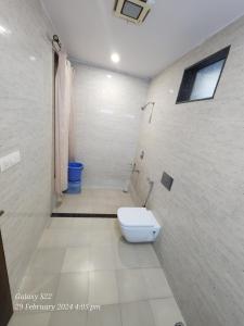 a bathroom with a white toilet in a room at Rani Palace Hotel And Resort in Kishangarh