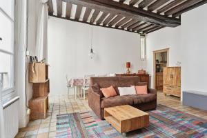 a living room with a couch and a coffee table at Appartement au coeur du Marais à Paris by Weekome in Paris