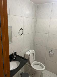a bathroom with a toilet and a sink at Apartamento em João Pessoa in João Pessoa