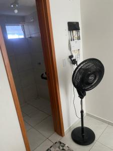 a bathroom with a shower and a fan in a room at Apartamento em João Pessoa in João Pessoa