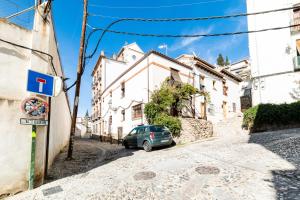 a small car parked on the side of a street at La Albaizinia in Granada