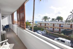 a balcony with a view of the ocean and a building at Cisne 32 in Playa del Ingles