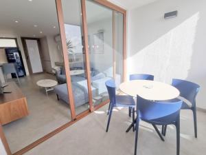 a room with a table and chairs and a bedroom at Cisne 32 in Playa del Ingles