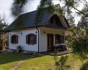 a white house with a black roof at Sielanka Siemiany in Siemiany +14 photos