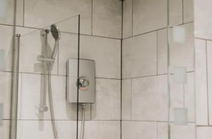 a shower with a shower head in a bathroom at Ranscombe House in Brixham