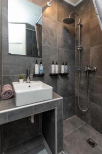 a bathroom with a sink and a shower at Houseloft White Tower Collection in Thessaloniki