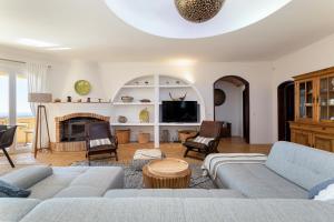 a living room with a couch and a fireplace at Casa Lusitania 19 in Faro