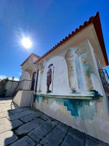 a building with a painting on the side of it at Casas Sebastião - Tourist House in Caminha