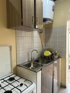 a kitchen with a sink and a stove at Villa Soto in Conakry