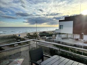 a balcony with a view of the beach and a building at Panoramic view Gavà Mar in Gavà