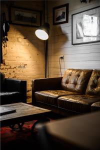 a living room with a leather couch and a table at Historic Cargo Inn Orange Food & Wine Region 
