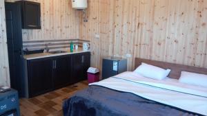 a bedroom with a bed and a sink in it at Rosemary Huts in Ajloun
