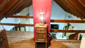 a attic room with a lamp on a dresser at Casa con pileta en Gonnet Bell in Manuel B. Gonnet
