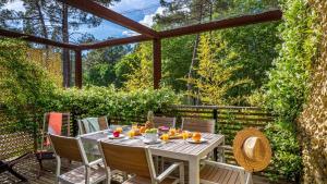 a patio with a table with fruit on it at Camping-Village Vacances Les deux Étangs in Seignosse