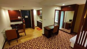 a hotel room with a desk and a bedroom at SUN GARDEN Studio and Residences at South China Sea Place Suites in Kota Kinabalu