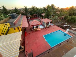 an overhead view of a house with a swimming pool at 5 Kesar Baug Resort in Ānjarle