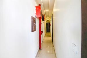 a hallway with a red fire hydrant in a building at FabHotel La Vista in Zirakpur