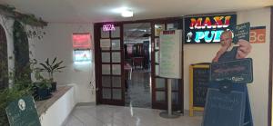 a entrance to a restaurant with a sign on the wall at Paraíso Maspalomas Experience in San Bartolomé +29 photos