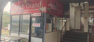een gebouw met een rood bord aan de zijkant bij Adith Grand in Tirupati