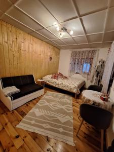a living room with two beds and a couch at Ziedu aleja in Sigulda
