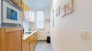 a kitchen with a sink and a microwave at strandnahe FeWo mit Schwimmbad im Haus, a cappella 68,Binz in Binz