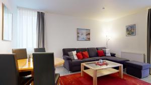 a living room with a couch and a table at strandnahe FeWo mit Schwimmbad im Haus, a cappella 68,Binz in Binz +21 photos