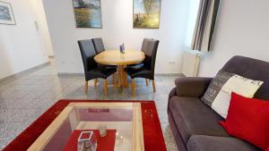 a living room with a couch and a table at strandnahe FeWo mit Schwimmbad im Haus, a cappella 68,Binz in Binz