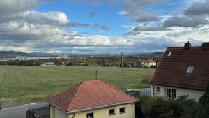 a view of a field and a house at 205 qm "Traumtor" mit Sauna, Whirlpool, Kamin und 3 Terrassen mit Blick in die Böhmisch Sächsische Schweiz in Dresden
