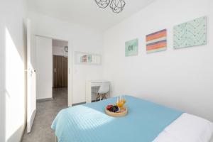 a room with a bed with a bowl of fruit on it at Seaside Apartment with Balcony in Pobierowo - Close to Beach by Renters in Pobierowo