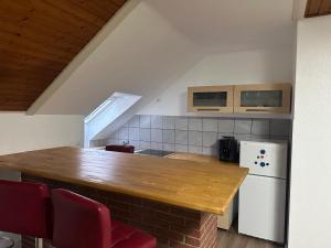 a kitchen with a wooden counter and a white refrigerator at Wolburg am Grossensee in Großensee