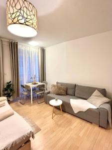 a living room with a couch and a table at Apartment Simona - Old Town in Bratislava