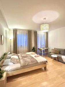 a bedroom with a large bed and a living room at Apartment Simona - Old Town in Bratislava