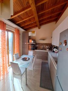 a kitchen with a table and chairs and a refrigerator at Casa Marzia&Daniele in Rome