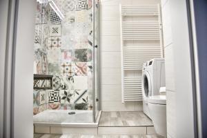 a bathroom with a shower and a toilet at Lagunenstadt am Haff GmbH in Ueckermünde +237 photos