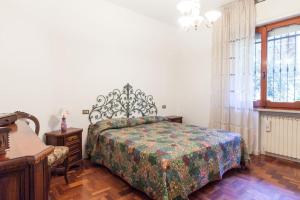 a bedroom with a bed and a table and a window at Villetta al mare in Rimini
