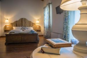 a bedroom with a bed and a table with books at La Vineria di San Mattia in Verona