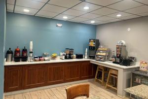 a kitchen with a counter and a blue wall at Days Inn by Wyndham Killeen Fort Hood in Killeen