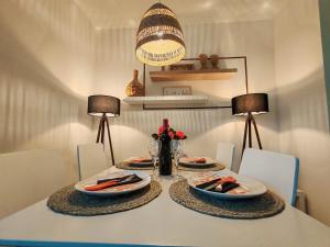 a dining table with two plates of food on it at La vita e bella in Prčanj
